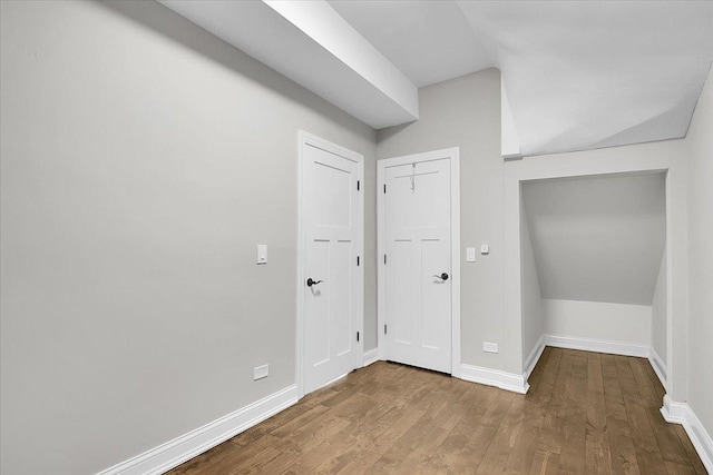 interior space with lofted ceiling and wood-type flooring