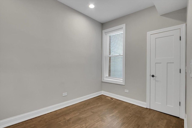 empty room featuring a healthy amount of sunlight and wood-type flooring