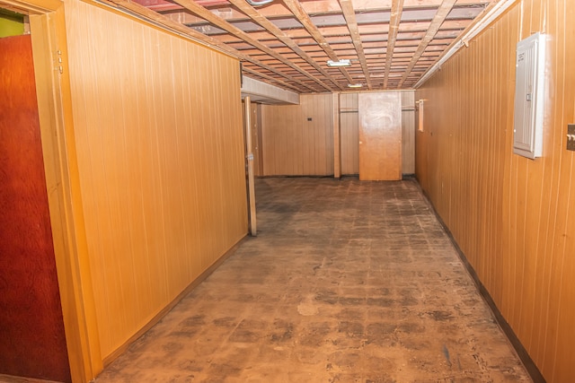 hallway featuring wood walls