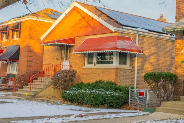 view of front of house featuring solar panels