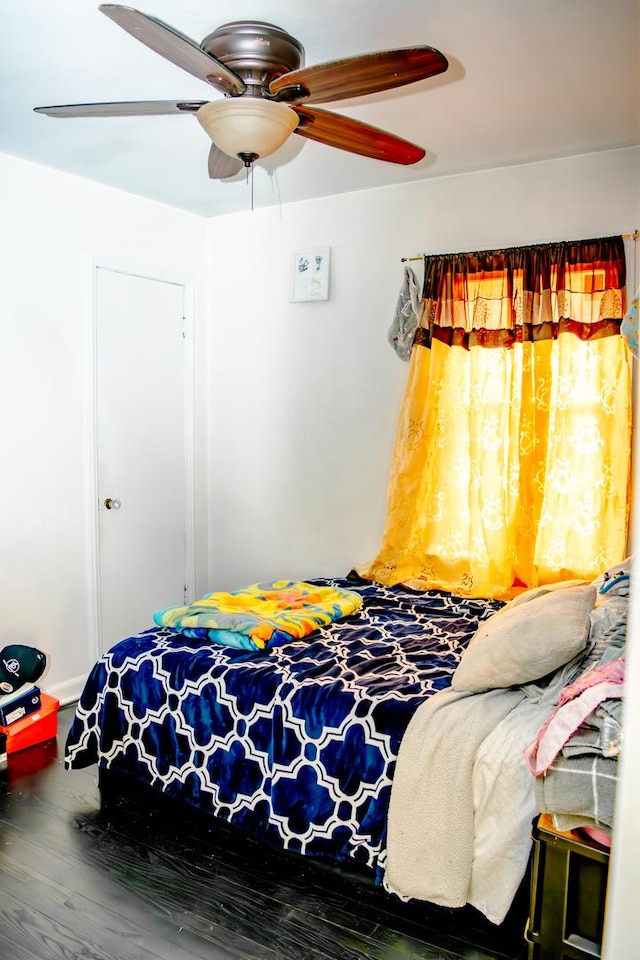 bedroom with ceiling fan and hardwood / wood-style flooring