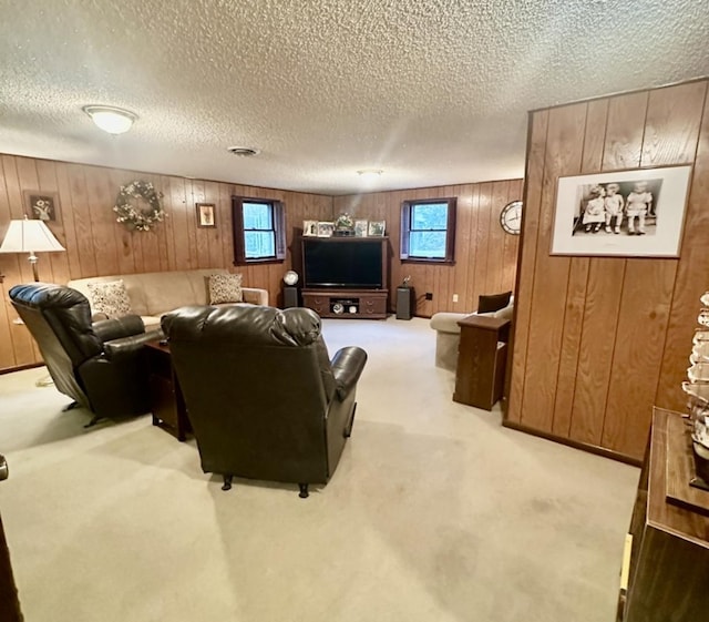 carpeted living room featuring a textured ceiling and wooden walls