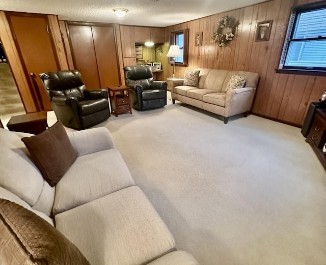 carpeted living room with a textured ceiling and wood walls