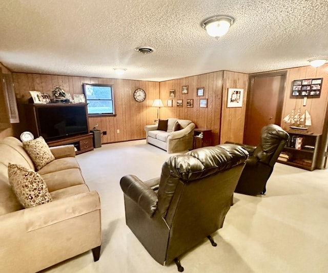 carpeted living room with wood walls and a textured ceiling