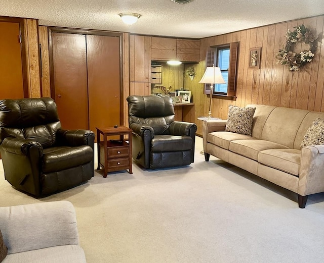 carpeted living room featuring a textured ceiling and wooden walls