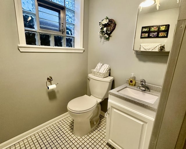 bathroom with tile patterned flooring, vanity, and toilet