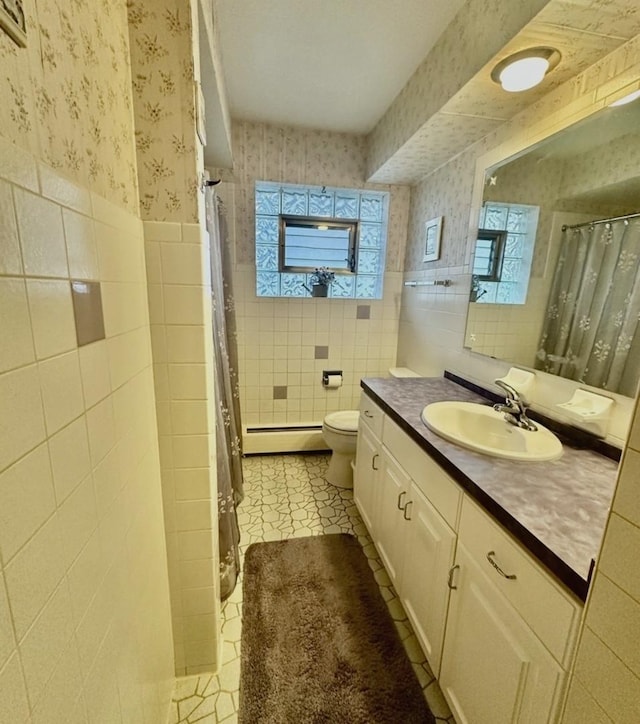 bathroom featuring tile patterned flooring, vanity, tile walls, and toilet