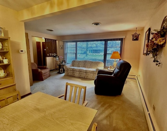 carpeted living room featuring a baseboard heating unit