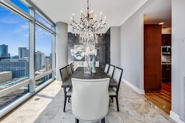 dining room featuring a wall of windows, crown molding, a wealth of natural light, and an inviting chandelier