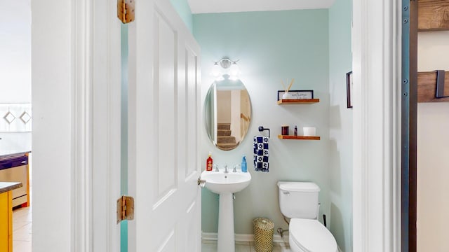 bathroom featuring tile patterned flooring and toilet