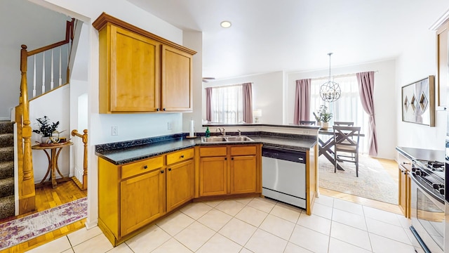 kitchen with sink, a chandelier, light tile patterned floors, appliances with stainless steel finishes, and pendant lighting