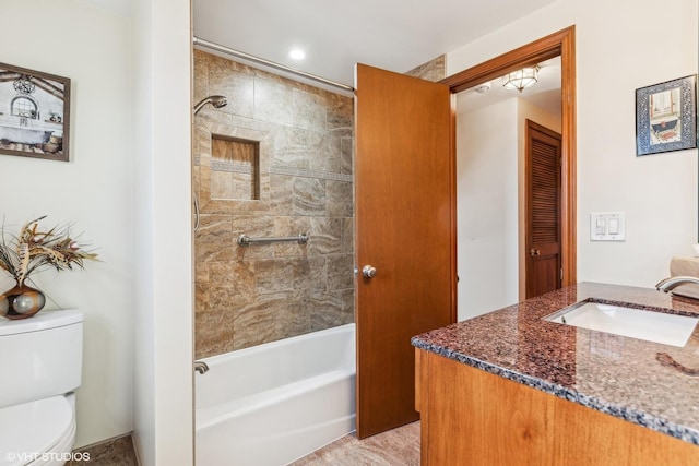 full bathroom featuring vanity, toilet, and tiled shower / bath combo