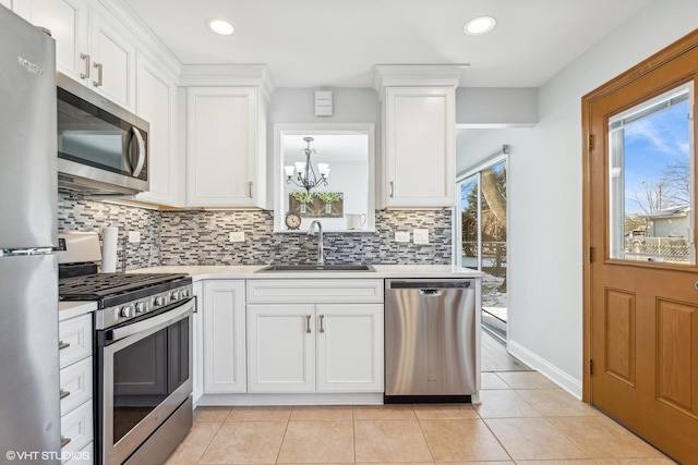 kitchen featuring sink, white cabinets, and appliances with stainless steel finishes