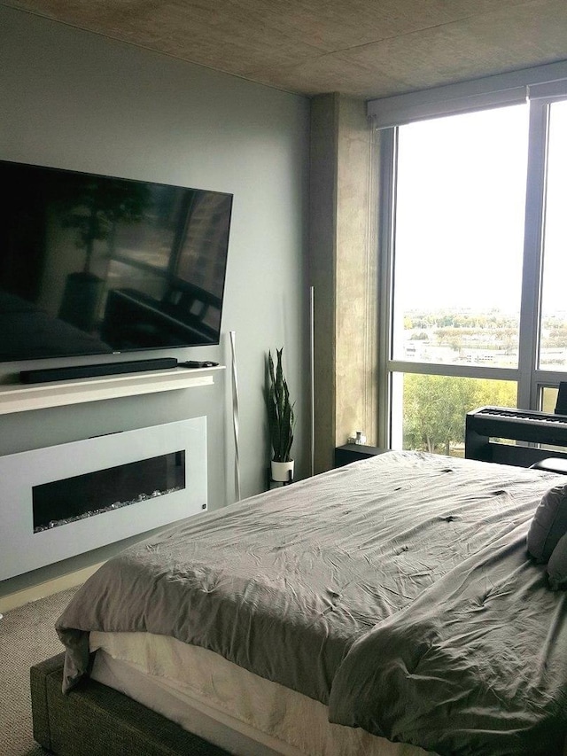 carpeted bedroom featuring multiple windows