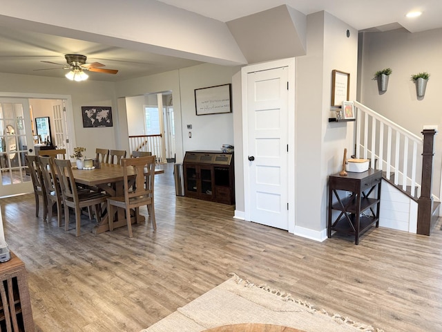 dining room with ceiling fan and light wood-type flooring