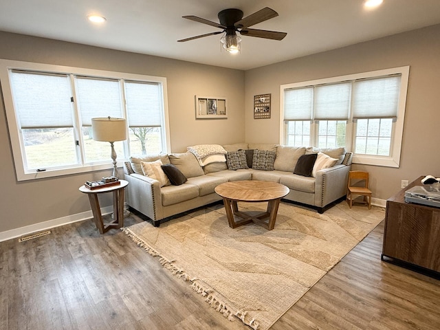 living room featuring ceiling fan and light wood-type flooring