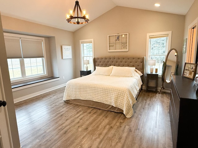 bedroom with multiple windows, dark hardwood / wood-style flooring, and lofted ceiling