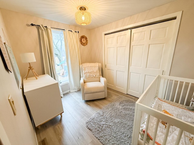 bedroom featuring a closet and light wood-type flooring