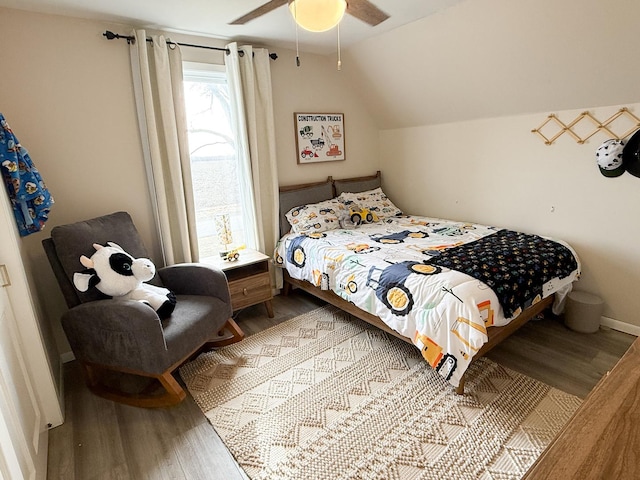 bedroom with vaulted ceiling, hardwood / wood-style floors, and ceiling fan