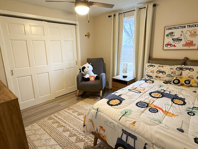 bedroom featuring hardwood / wood-style floors, ceiling fan, and a closet