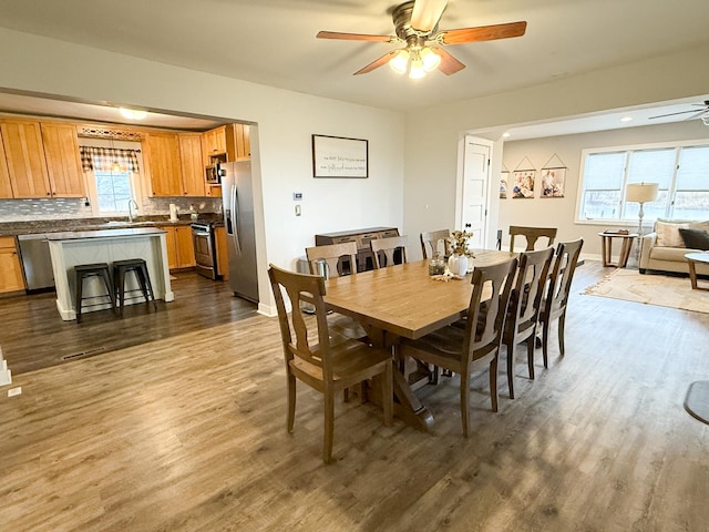 dining room with hardwood / wood-style flooring and ceiling fan