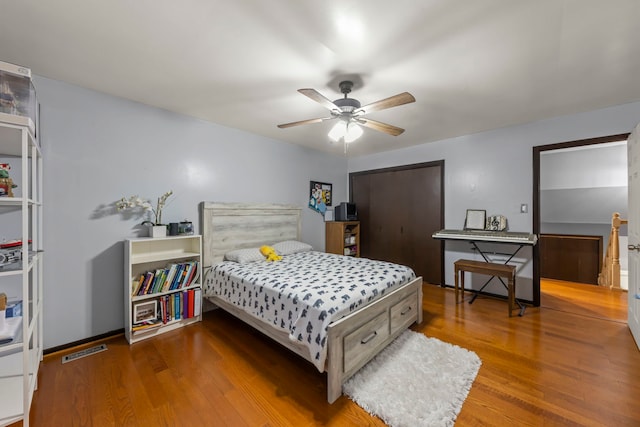 bedroom with ceiling fan and wood-type flooring