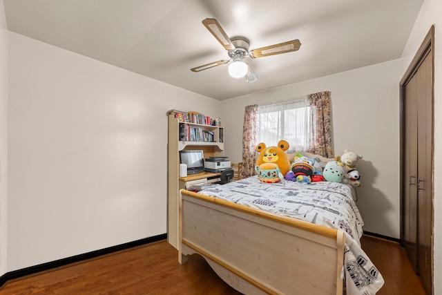 bedroom with ceiling fan and dark wood-type flooring