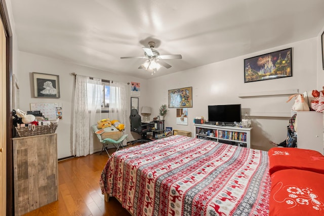 bedroom with ceiling fan and wood-type flooring