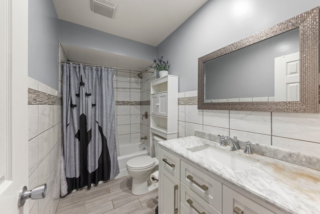 full bathroom featuring vanity, toilet, tile walls, and shower / tub combo with curtain