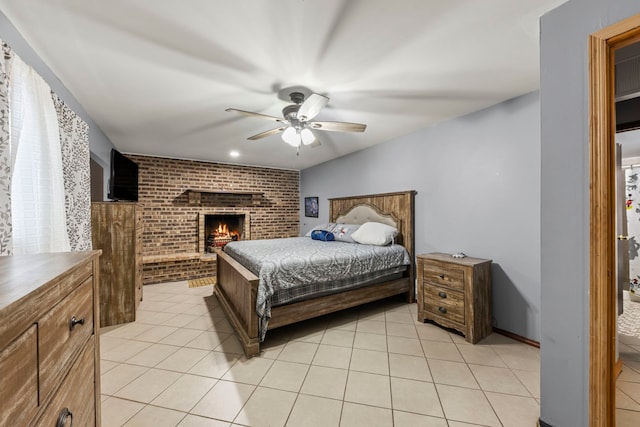 tiled bedroom with a brick fireplace and ceiling fan