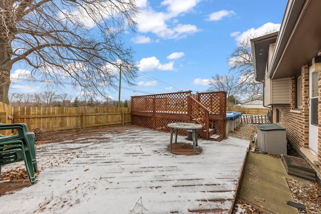 snow covered patio with a pool side deck