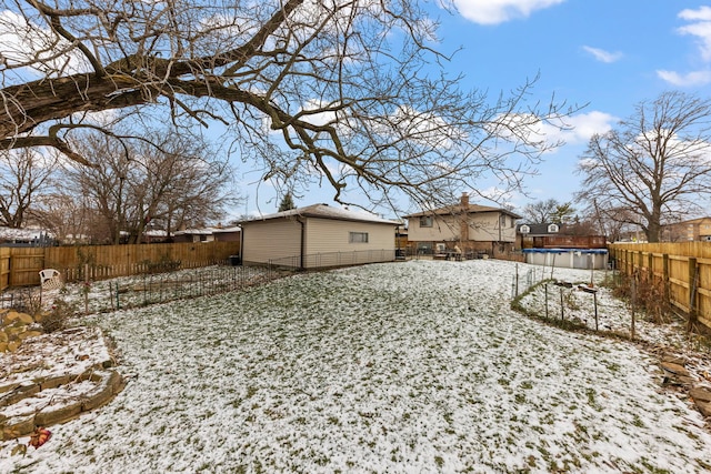 yard layered in snow featuring a fenced in pool