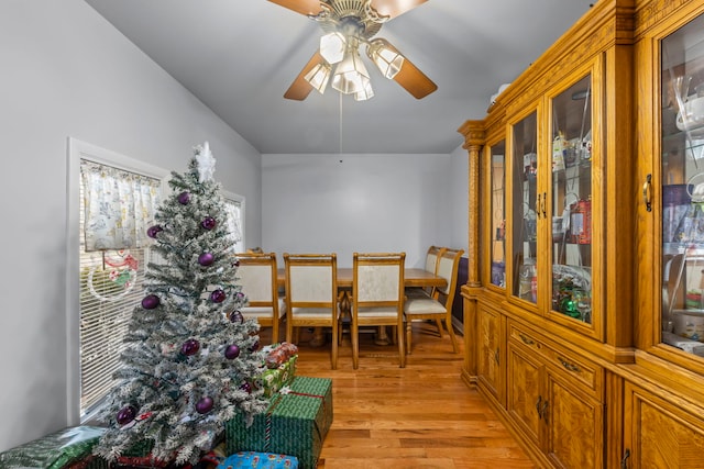 dining area with light hardwood / wood-style floors and ceiling fan