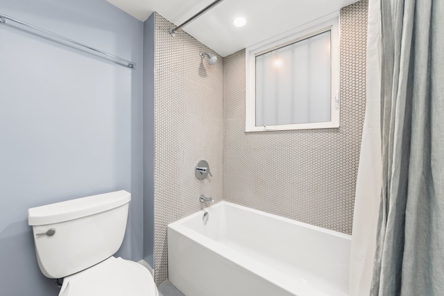 bathroom with toilet and shower / bathtub combination with curtain