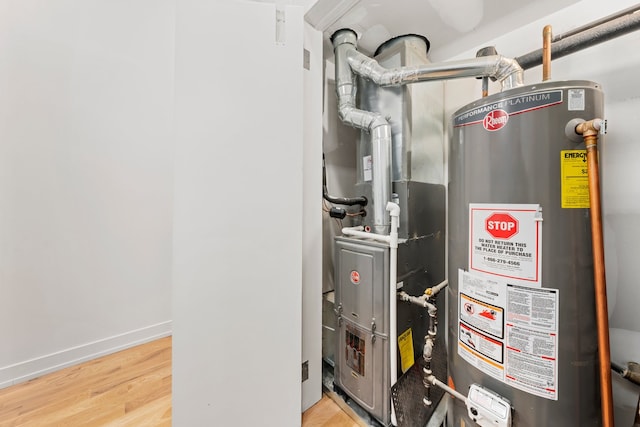 utility room featuring heating unit and gas water heater