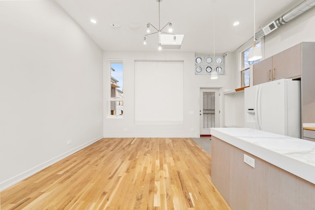 unfurnished dining area featuring light wood-type flooring