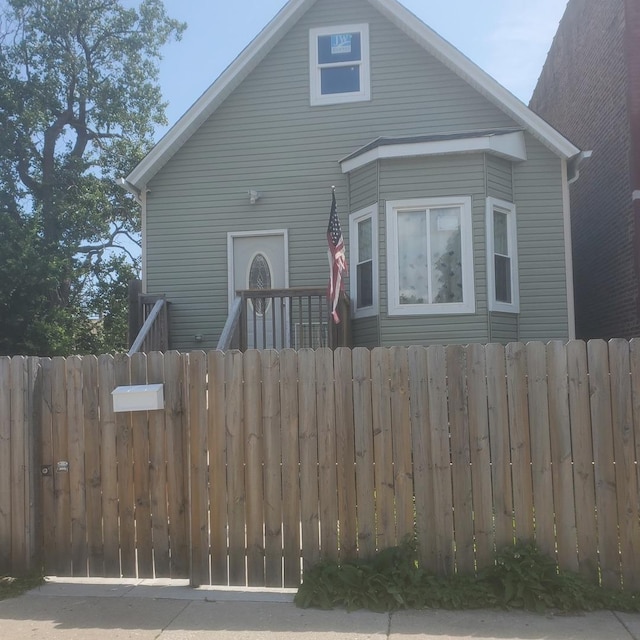 bungalow-style house with fence