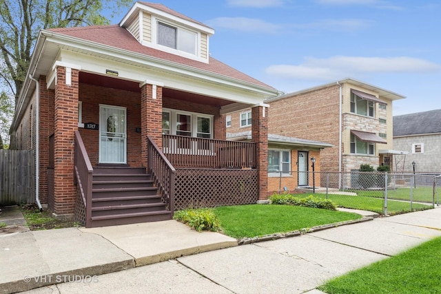 view of front of home featuring a front yard and a porch