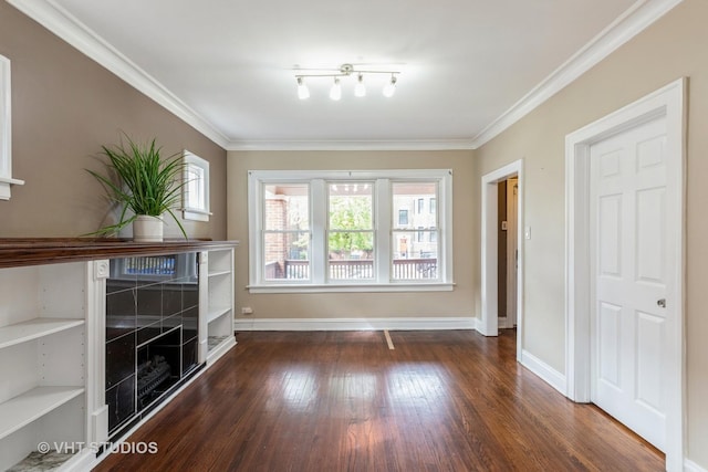 unfurnished living room with plenty of natural light, dark hardwood / wood-style floors, and ornamental molding