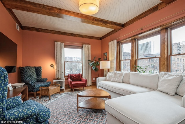 living room with hardwood / wood-style flooring and beamed ceiling