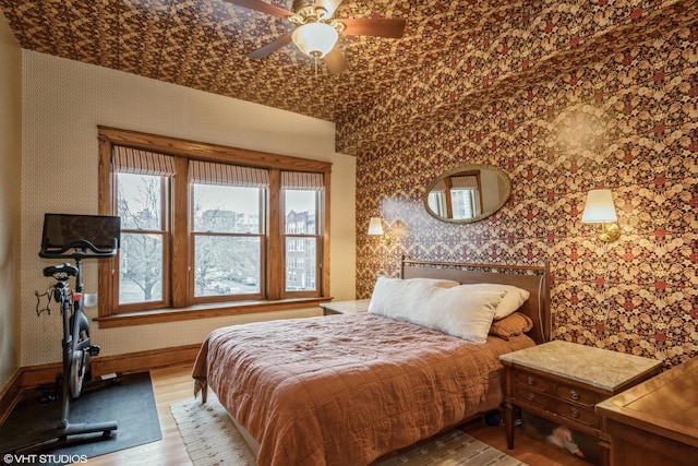 bedroom with ceiling fan and hardwood / wood-style flooring