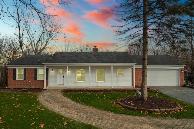 ranch-style house with a yard and a garage