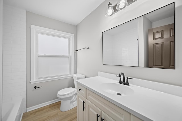 full bathroom featuring bathing tub / shower combination, hardwood / wood-style floors, vanity, and toilet