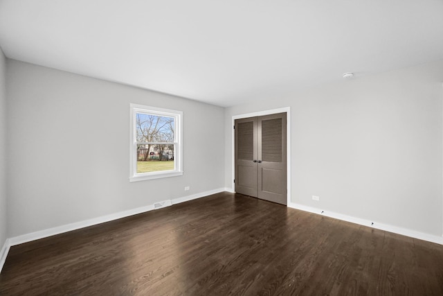 spare room featuring dark hardwood / wood-style floors