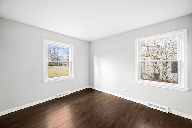 spare room with hardwood / wood-style floors and a wealth of natural light