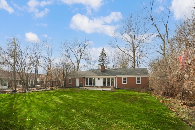 rear view of property with a lawn and a patio area