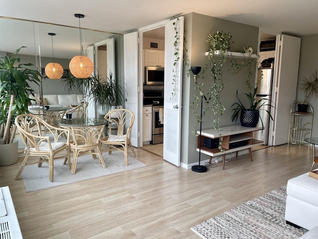 dining room featuring light hardwood / wood-style flooring