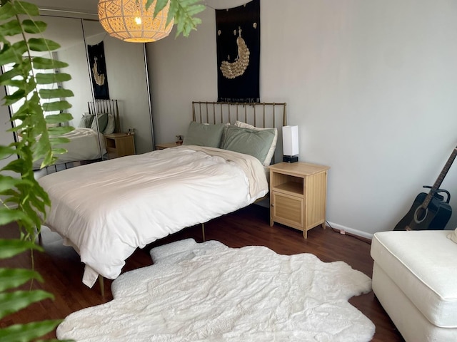 bedroom with dark hardwood / wood-style flooring