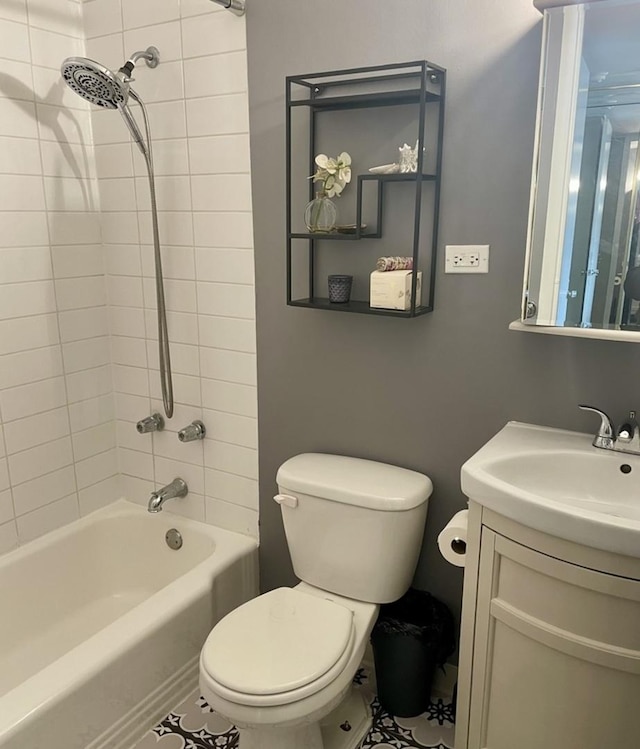 full bathroom with tiled shower / bath, tile patterned flooring, vanity, and toilet