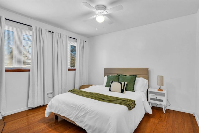 bedroom with ceiling fan and hardwood / wood-style floors